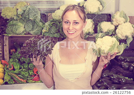 young woman buying cabbage at market. young woman buying cabbage at market. 26122756