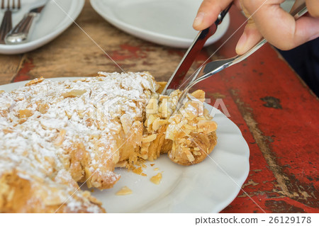 Fresh baked Croissant with Almond topping 26129178