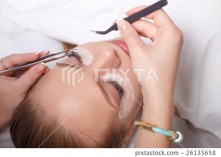 Eyelash Extension Procedure. Woman Eye with Long 26135658
