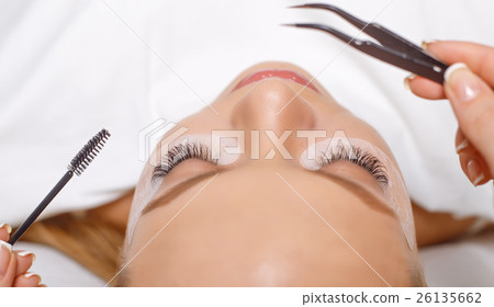 Eyelash Extension Procedure. Woman Eye with Long 26135662