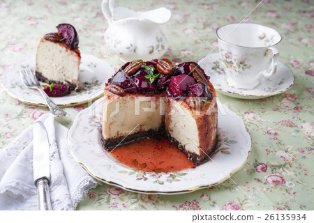 Cheesecake with Plum and Pecan Nut on Plate 26135934
