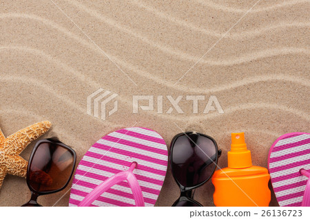 Accessories for the beach lying on the sand 26136723