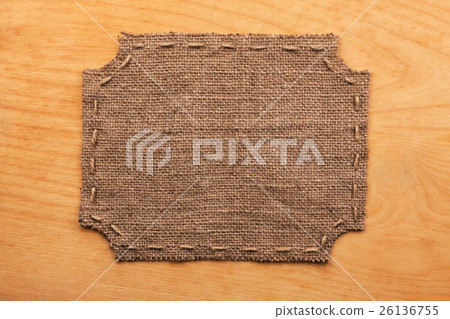Frame of burlap, lies on a background of wood Frame of burlap, lies on a background of wood 26136755