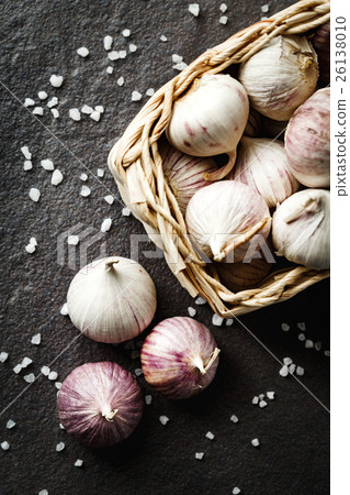 Garlic gloves in a basket on dark grey background 26138010