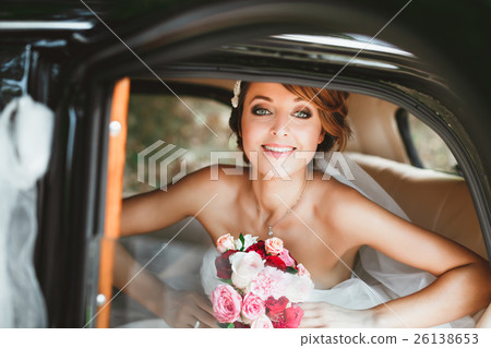 Beautiful bride sitting in wedding car Beautiful bride sitting in wedding car 26138653