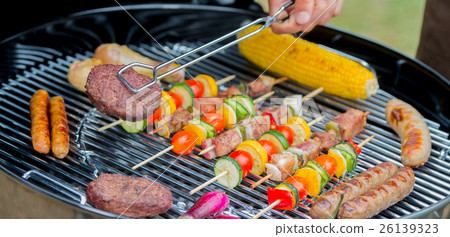 Service of meat on plate during a barbecue Service of meat on plate during a barbecue 26139323