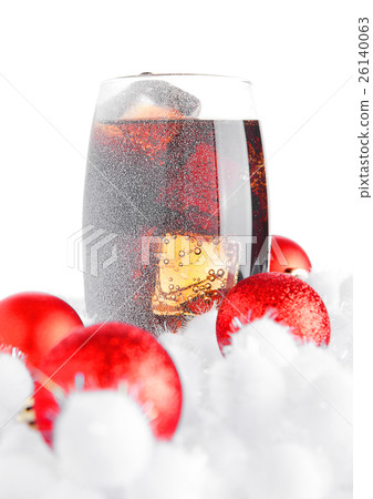 Glass of cola soda on snow and christmas balls Glass of cola soda on snow and christmas balls 26140063