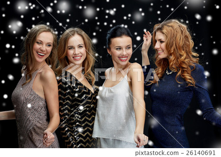 happy young women dancing over snow happy young women dancing over snow 26140691