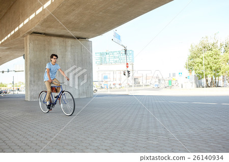 young hipster man riding fixed gear bike 26140934