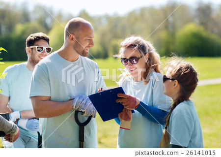 group of volunteers planting trees in park 26141015