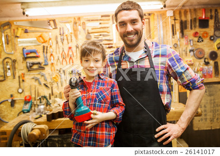 father and son with drill working at workshop 26141017