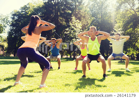 group of friends or sportsmen exercising outdoors 26141179