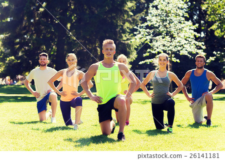 group of friends or sportsmen exercising outdoors 26141181