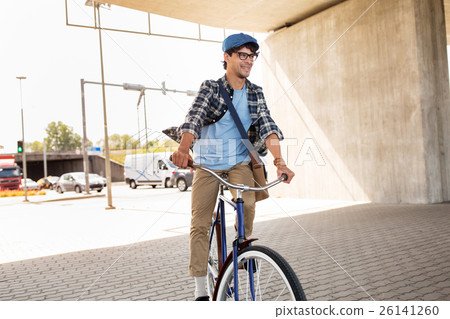 young hipster man with bag riding fixed gear bike 26141260