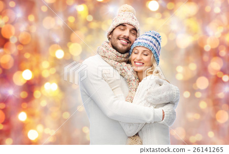 smiling couple in winter clothes hugging 26141265