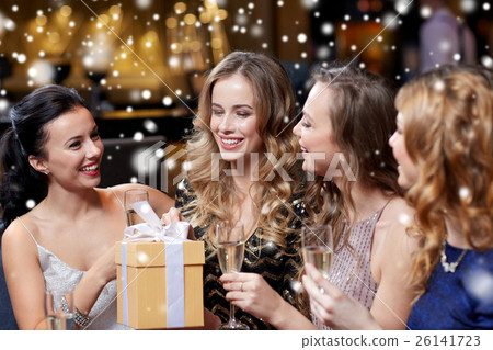 happy women with champagne and gift at night club 26141723