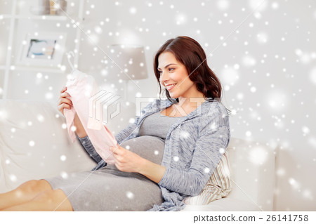 happy woman holding baby girls bodysuit at home happy woman holding baby girls bodysuit at home 26141758