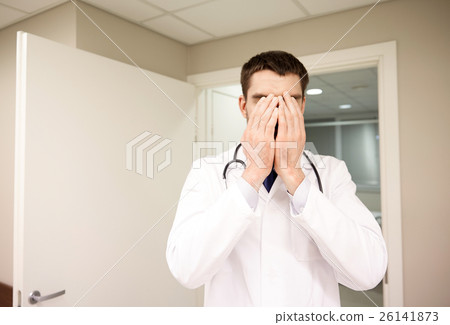 sad or crying male doctor at hospital ward 26141873