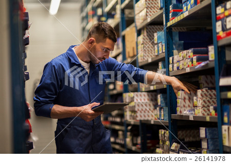 auto mechanic or smith with tablet pc at workshop auto mechanic or smith with tablet pc at workshop 26141978