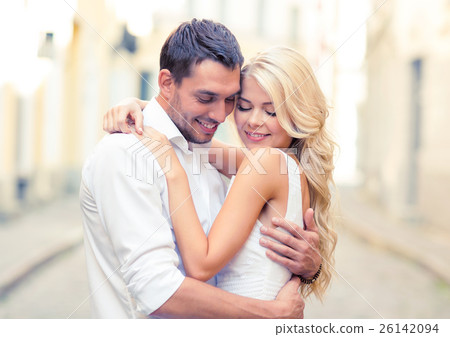 romantic happy couple hugging in the street 26142094