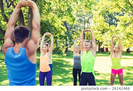group of friends or sportsmen exercising outdoors group of friends or sportsmen exercising outdoors 26142466