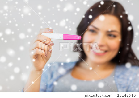 close up of happy woman with home pregnancy test 26142519