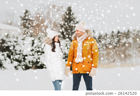 happy couple walking over winter background happy couple walking over winter background 26142520