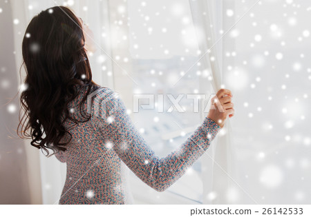 close up of woman opening window curtains 26142533
