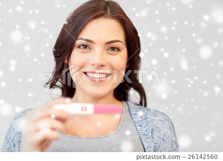 happy smiling woman holding home pregnancy test happy smiling woman holding home pregnancy test 26142560