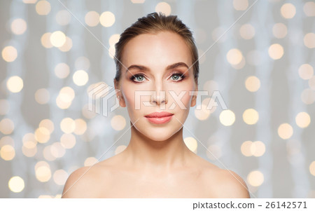 beautiful young woman face over holidays lights beautiful young woman face over holidays lights 26142571