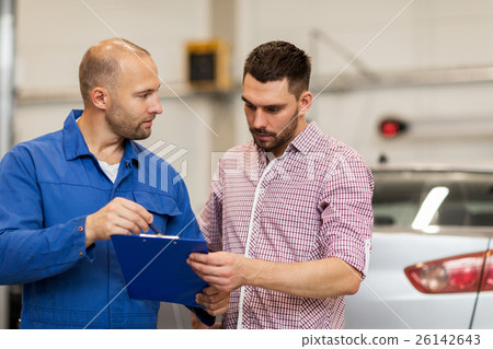 auto mechanic with clipboard and man at car shop 26142643