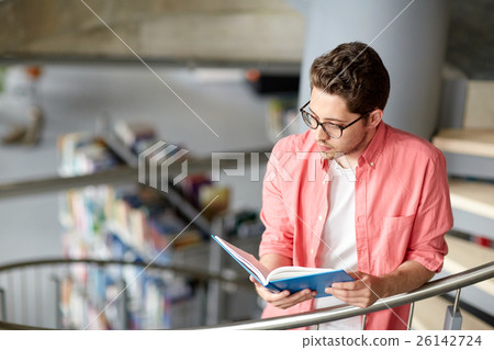 student boy or young man reading book at library student boy or young man reading book at library 26142724