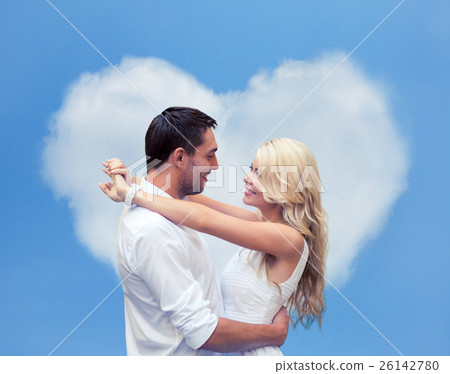 happy couple hugging over heart shaped cloud happy couple hugging over heart shaped cloud 26142780