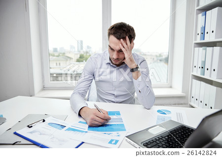 stressed businessman with papers in office stressed businessman with papers in office 26142824