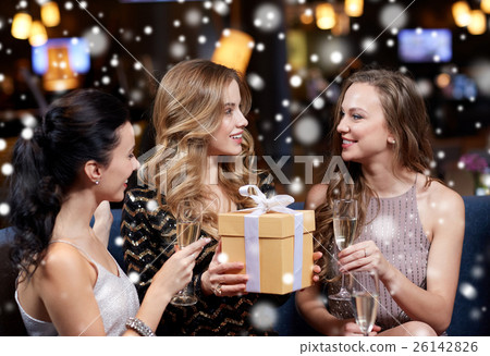 happy women with champagne and gift at night club happy women with champagne and gift at night club 26142826