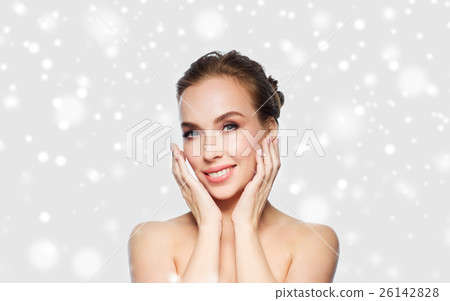 beautiful young woman touching her face over snow beautiful young woman touching her face over snow 26142828