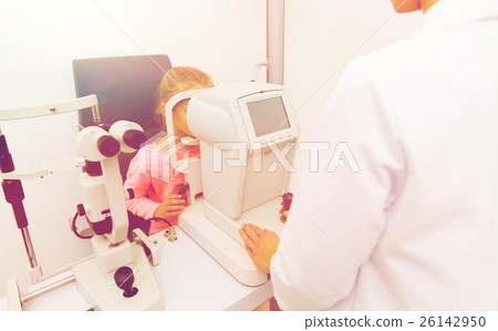 optician with autorefractor and kid at eye clinic 26142950