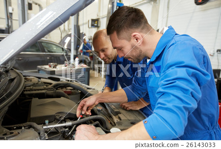mechanic men with wrench repairing car at workshop 26143033