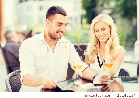 happy couple with wallet and bill at restaurant happy couple with wallet and bill at restaurant 26143154
