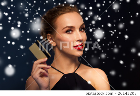 beautiful woman with credit card over snow 26143205