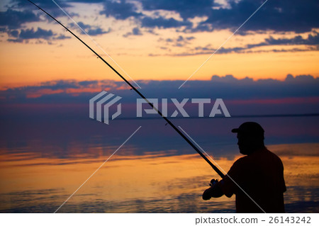 Silhouette of fishermen on quiet ocean with rays 26143242