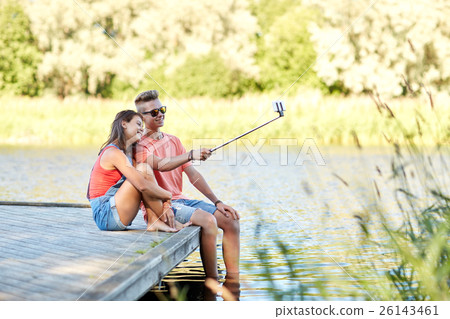 happy teenage couple taking selfie on smartphone 26143461