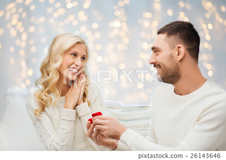 happy man giving engagement ring to woman happy man giving engagement ring to woman 26143646