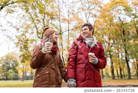 happy couple with coffee walking in autumn park 26143726