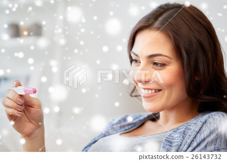happy woman looking at home pregnancy test happy woman looking at home pregnancy test 26143732