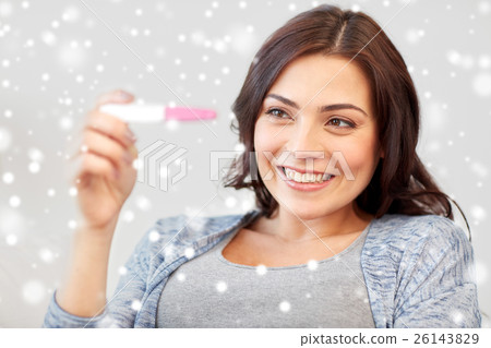 happy woman looking at home pregnancy test happy woman looking at home pregnancy test 26143829