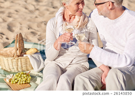 happy senior couple having picnic on summer beach happy senior couple having picnic on summer beach 26143850