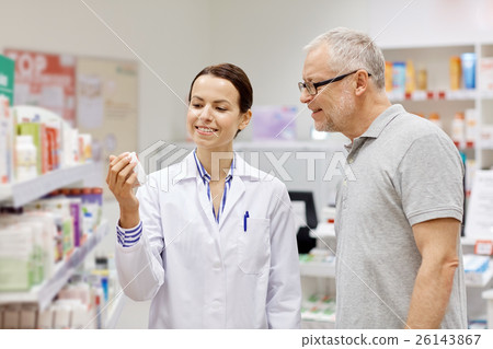 pharmacist showing drug to senior man at pharmacy pharmacist showing drug to senior man at pharmacy 26143867