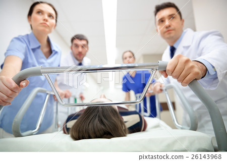 medics and patient on hospital gurney at emergency 26143968