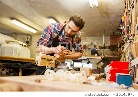 carpenter working with plane and wood at workshop carpenter working with plane and wood at workshop 26143973